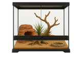 Glass reptile terrarium with sand substrate, cave hide, artificial plant, branch, and water dish