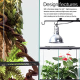 Glass reptile terrarium with artificial vines, plants, and overhead heat lamp